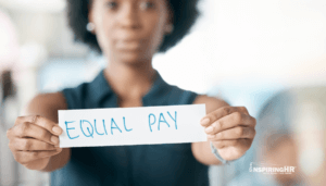 Woman holding equal pay sign; pay equity