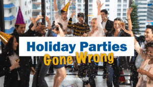 Office workers celebrating and throwing confetti at a office holiday party.
