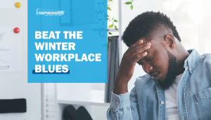 Man with hand on head showing signs workplace winter blues.